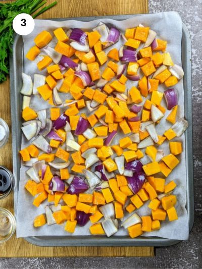 Seasoning the squash and onion before roasting.