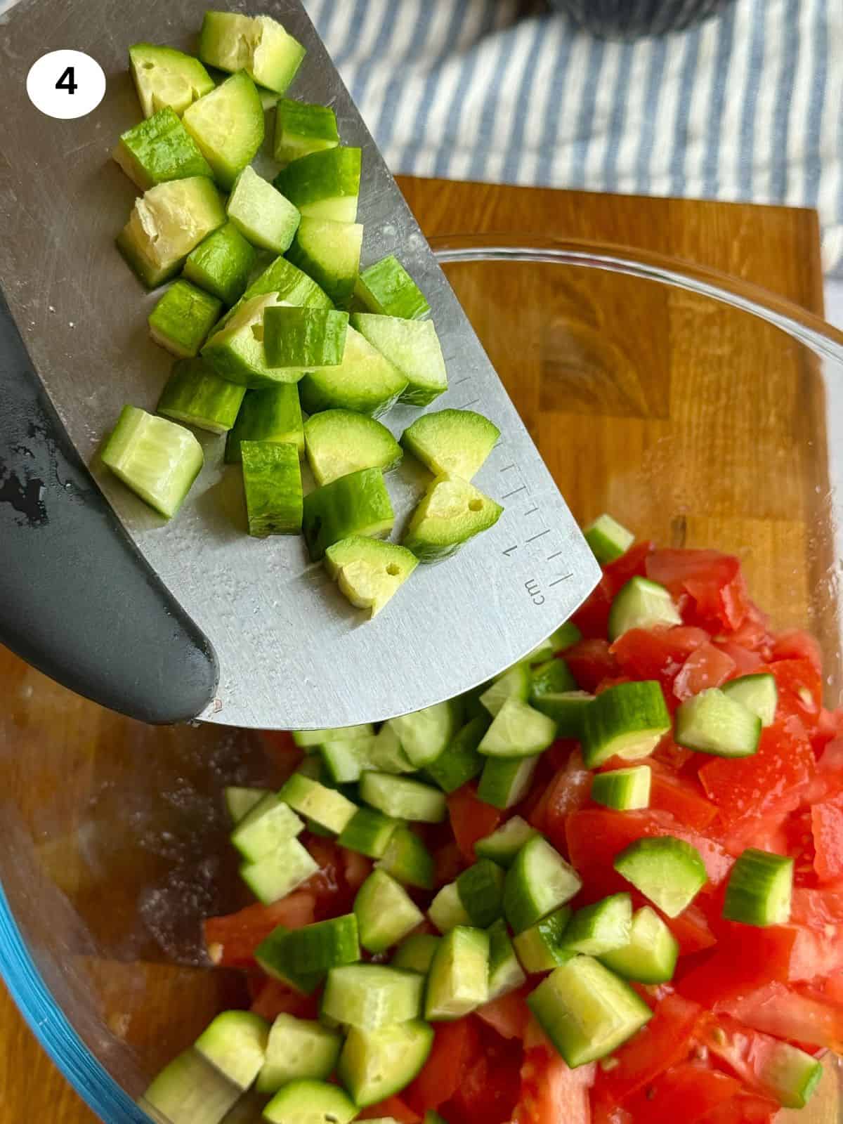 Adding cucumber slices to salad bowl.