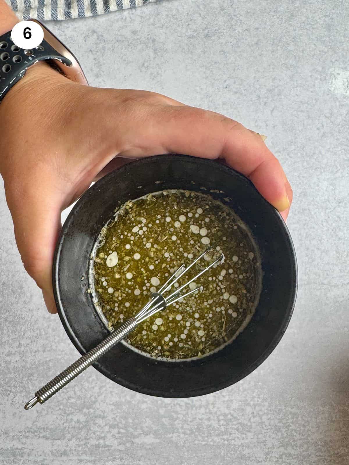 Mixed dressing in a black bowl.