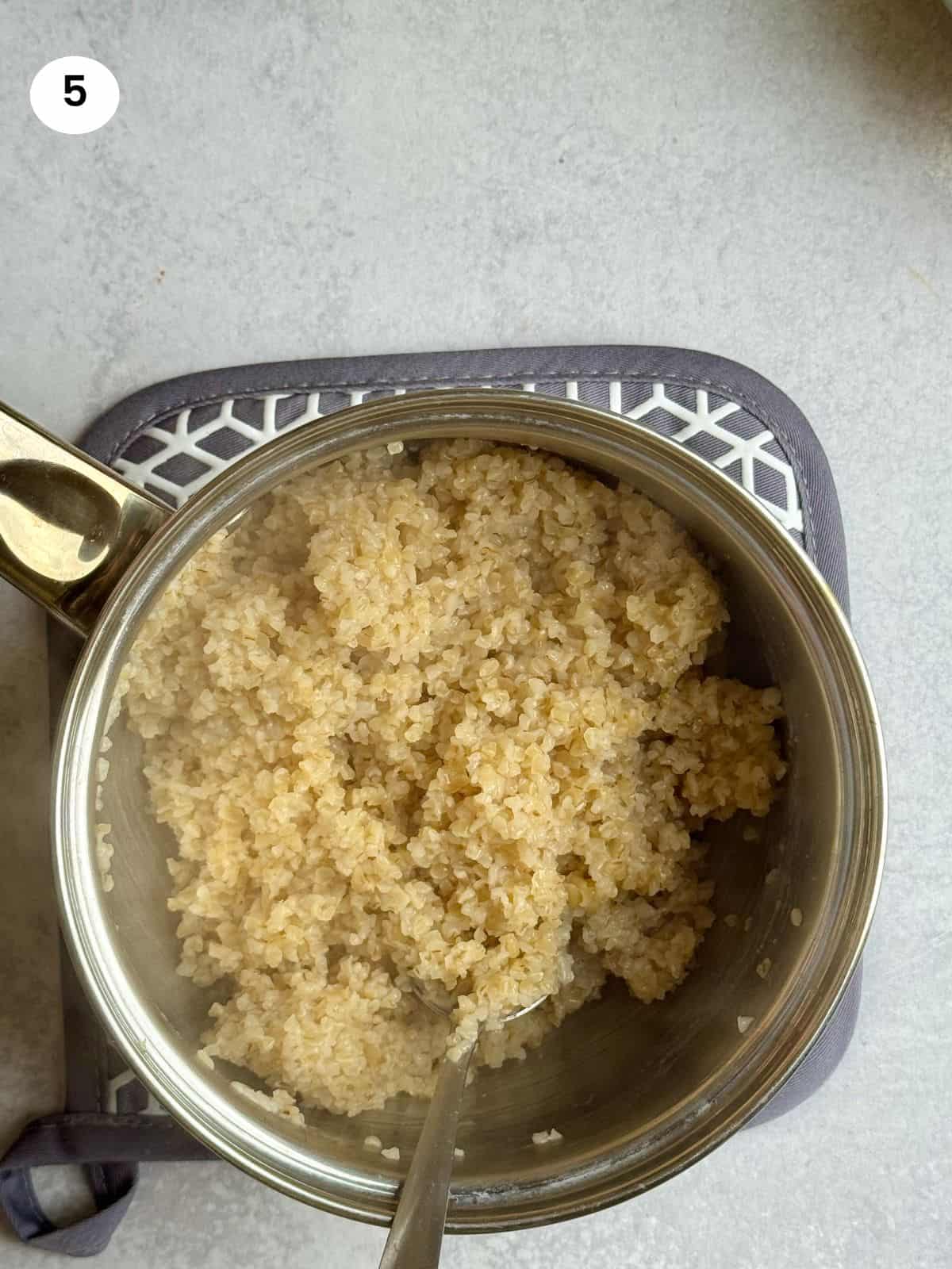 Fluffed bulgur wheat in a small pot.