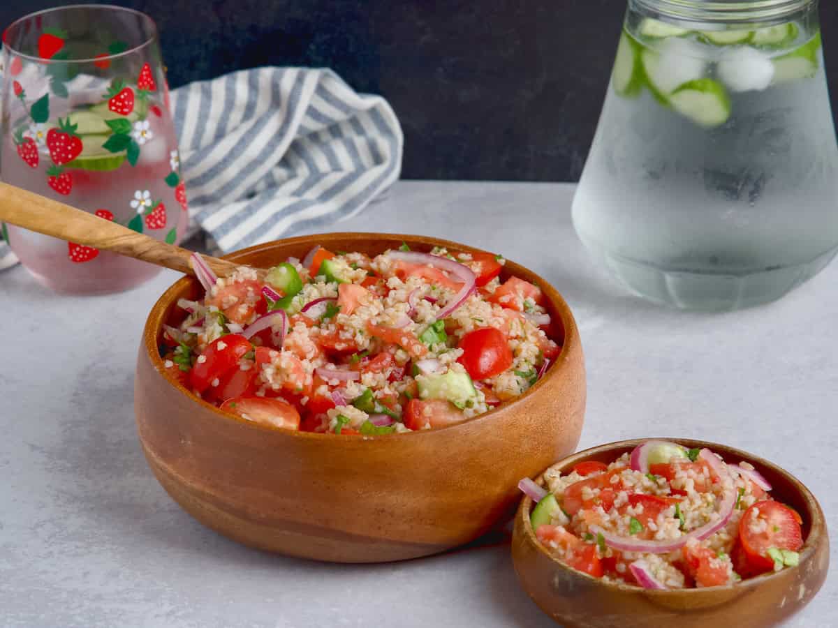 Cucumber, tomato and bulgur salad served in a wooden bowl Cucumber, tomato and bulgur salad served in a wooden bowl.