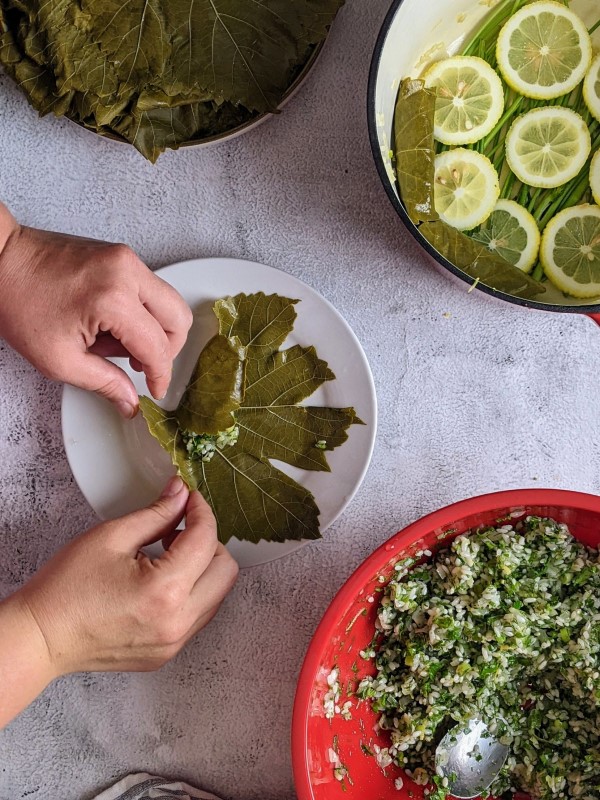 Folding the bottom of the grape leaf.