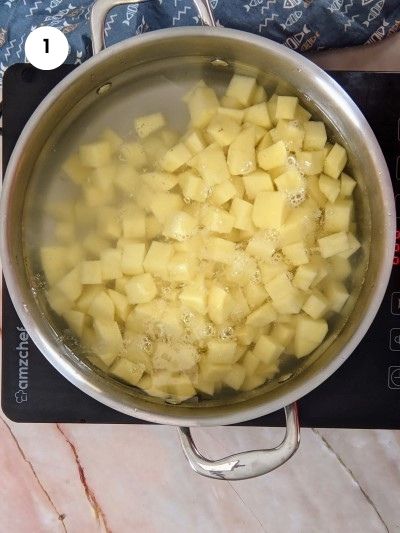 Boiling the potatoes cubes.