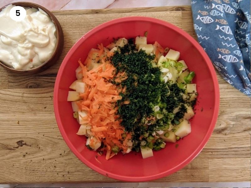 All potato salad ingredients inside the bowl and ready to mix.