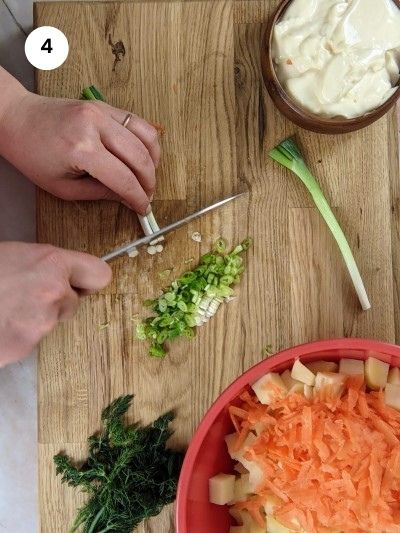 Chopping green onions for the potato salad.