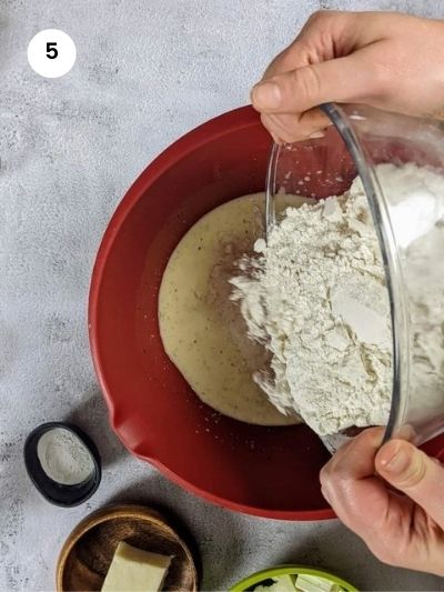 Adding the flour to the wet ingredients.