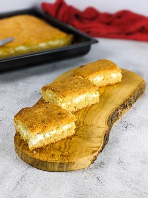 Three feta bread slices on a wooden board.