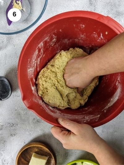 Kneading the dough until all flour is incorporated.