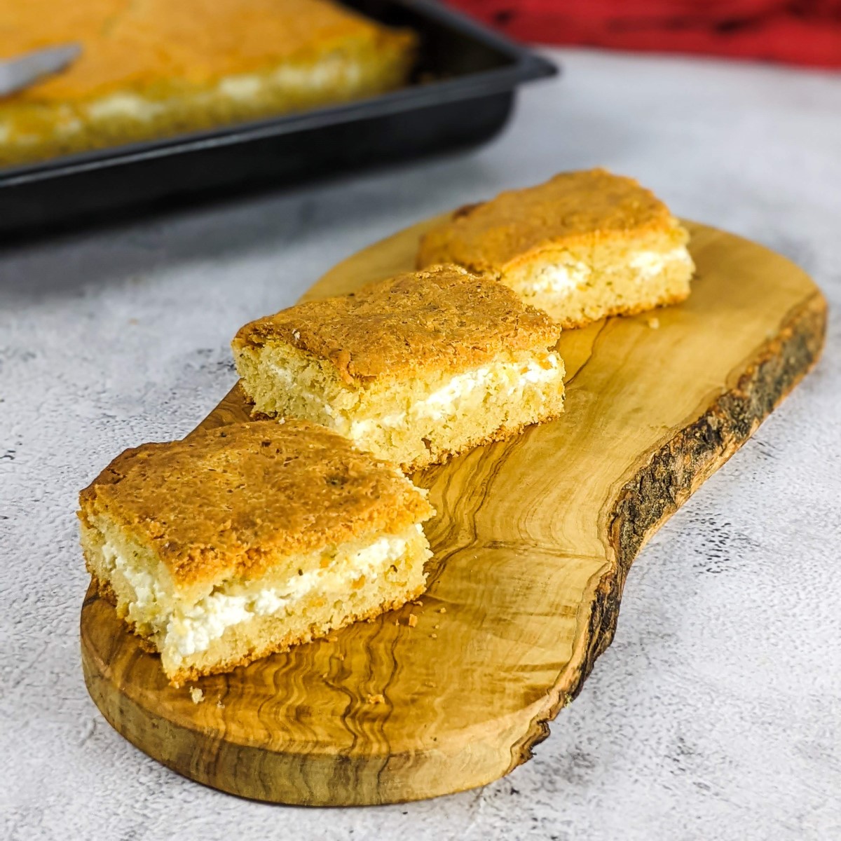 Three feta bread slices on a wooden board.