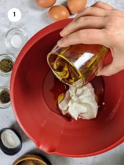 Mixing the yogurt and olive oil in a big bowl.