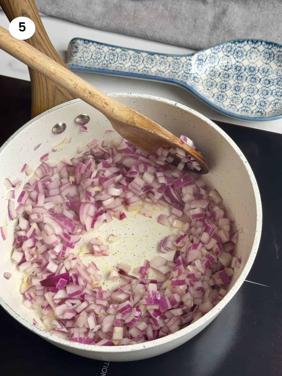 Sauteing the red onion.