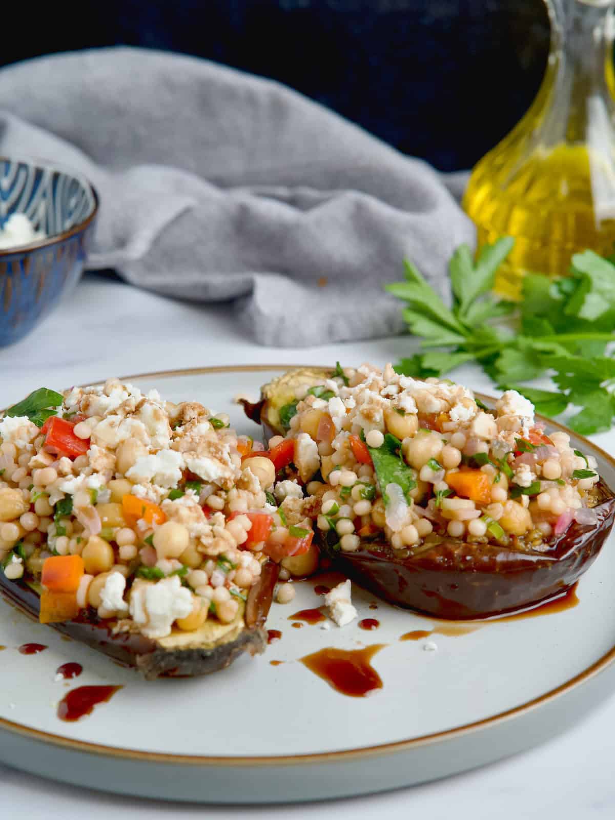 Roasted eggplants with couscous filling served on a plate Roasted eggplants with couscous filling served on a plate.