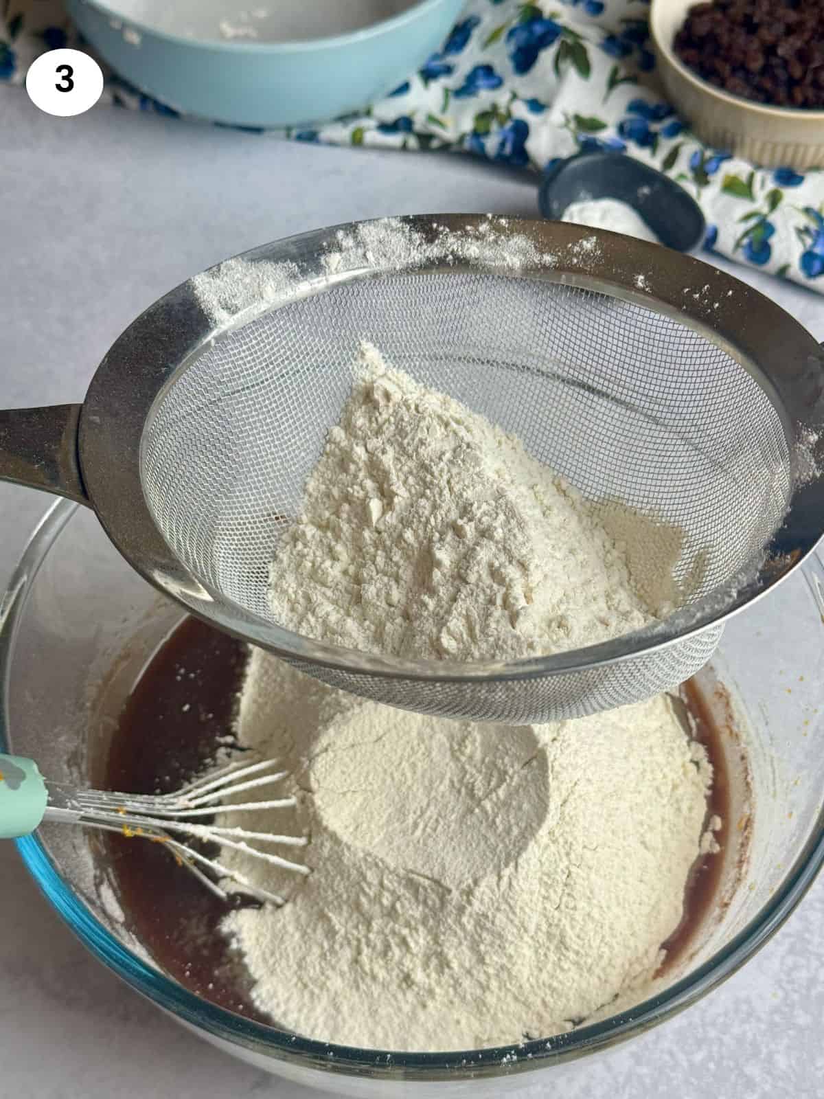 Sifting the flour on top of the bowl.