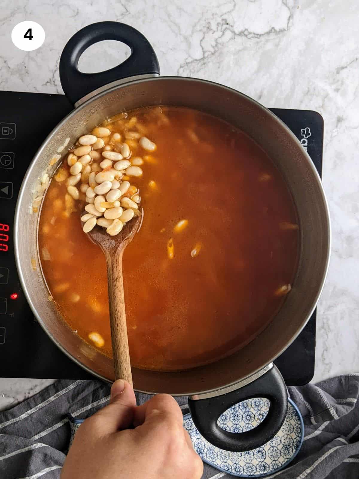 Added white beans and water to the pot.