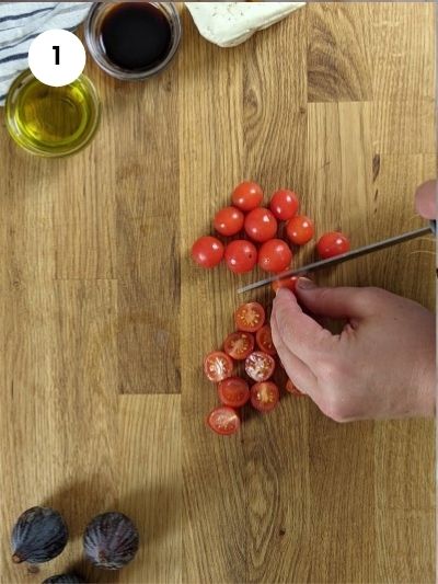 Cutting the cherry tomatoes in two.