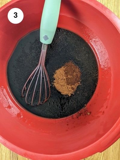 Adding the ground cinnamon and clove to the mixture.