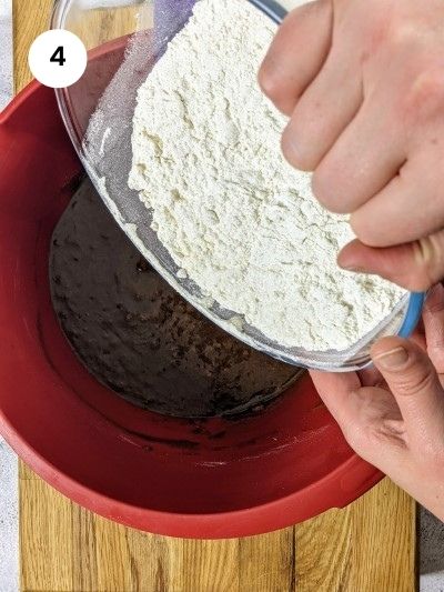 Slowly adding the flour for the grape molasses cookies.