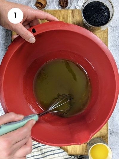 Mixing oil and sugar for the grape molasses cookies.