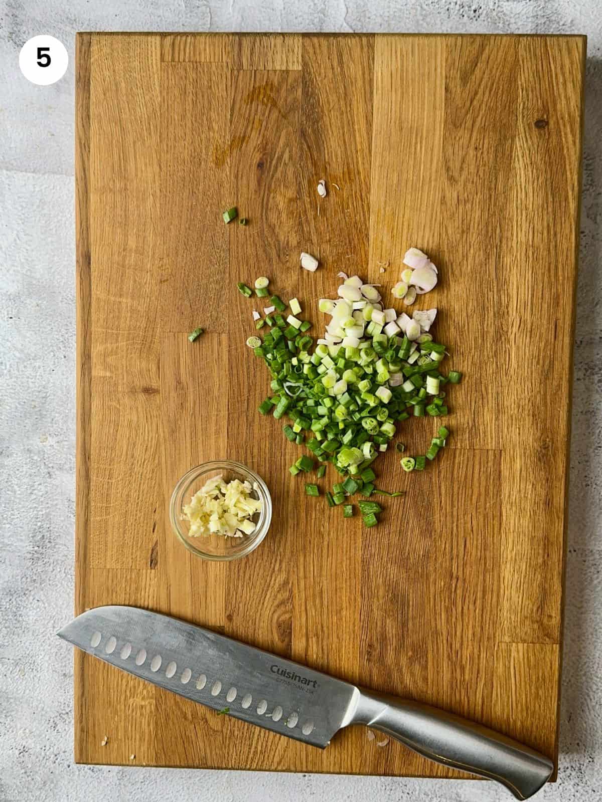 Cutting the green onions and garlic cloves.