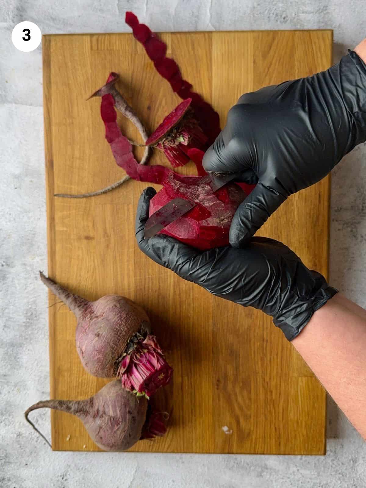 Peeling beet before cutting it.