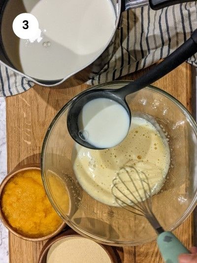 Adding hot milk to eggs and sugar mixture.