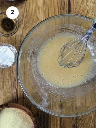 Mixing eggs and sugar in a bowl.