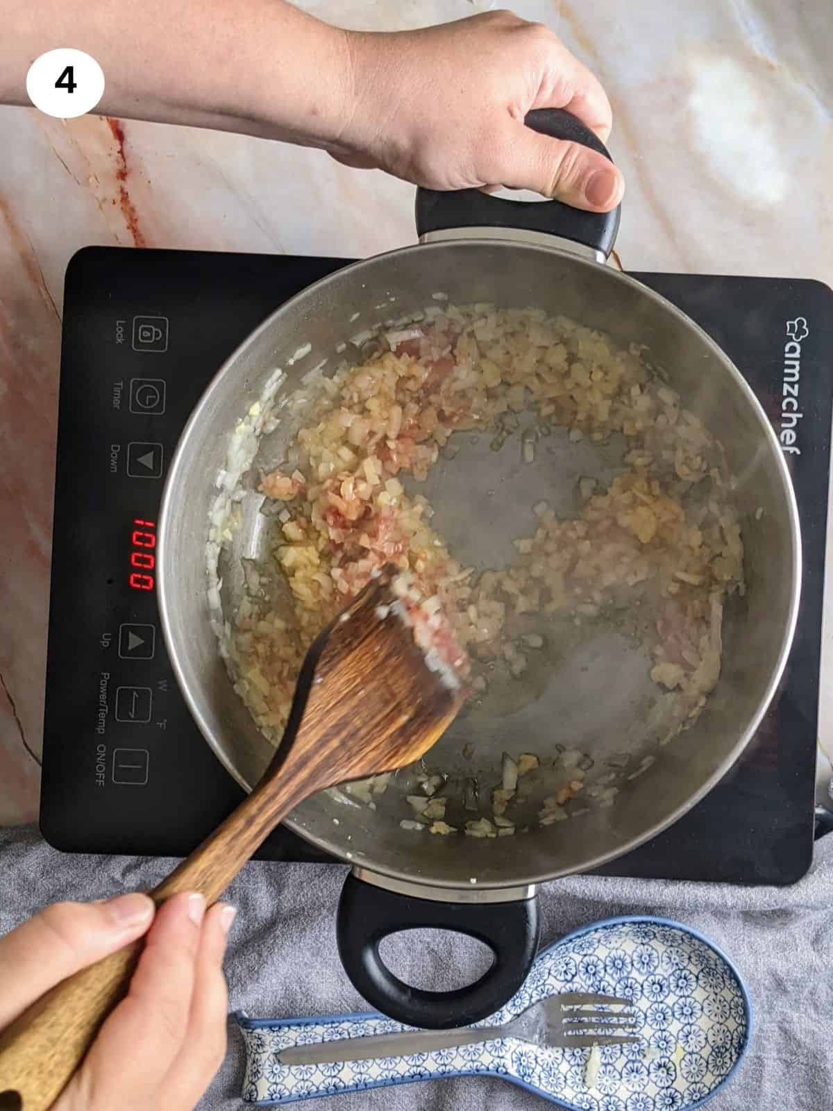 Sauteing the onion, garlic and tomato paste.