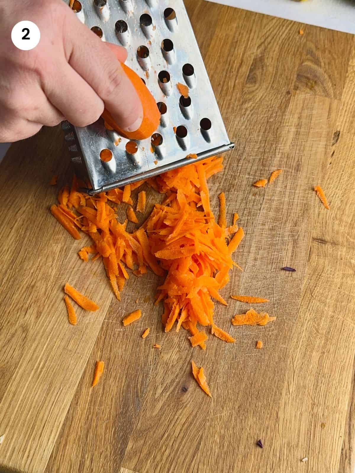 Grating the carrot for lahanosalata.