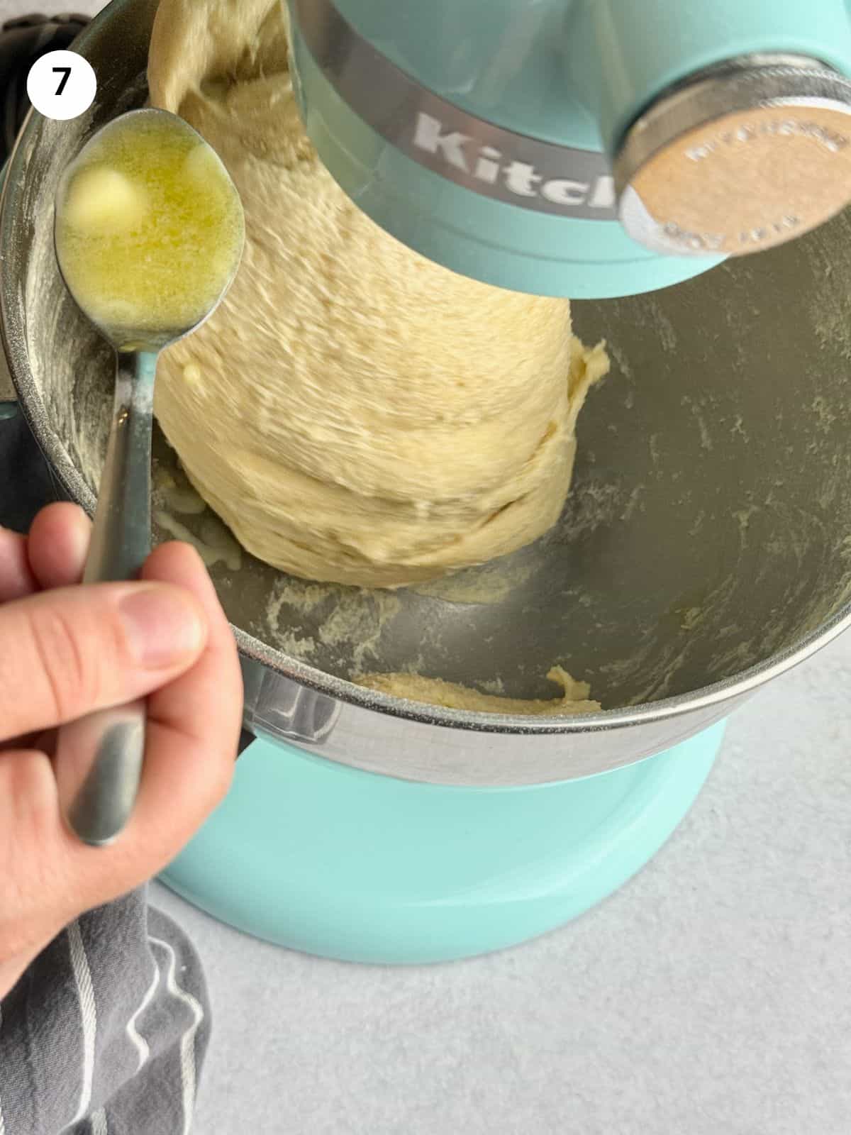 Adding the butter spoon by spoon.