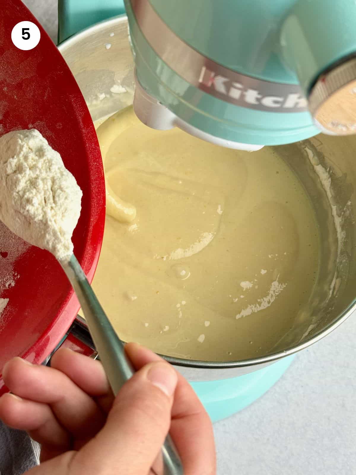 Adding the flour to the bowl for mixing.