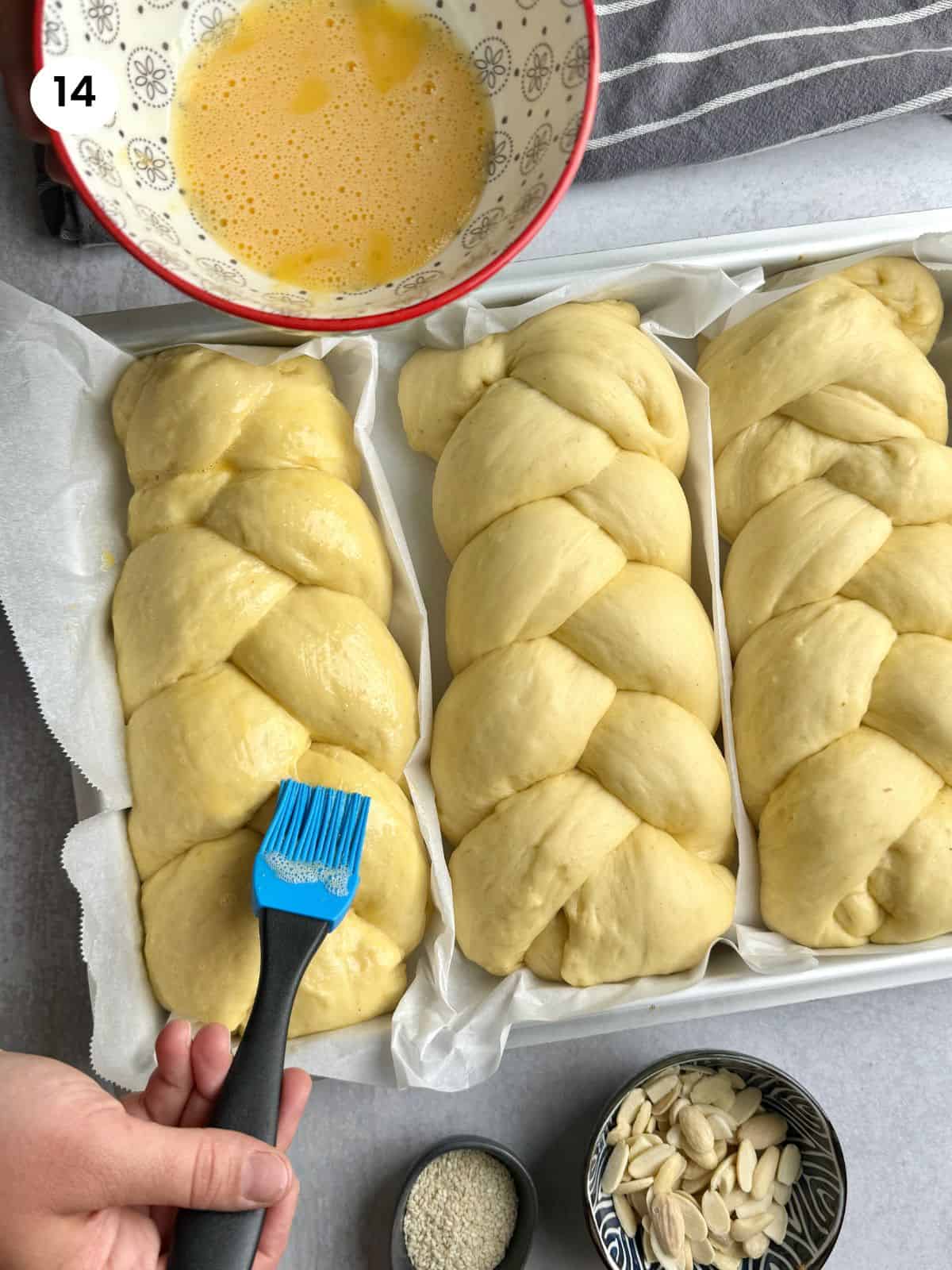 Brushing the sweet bread with beaten egg.