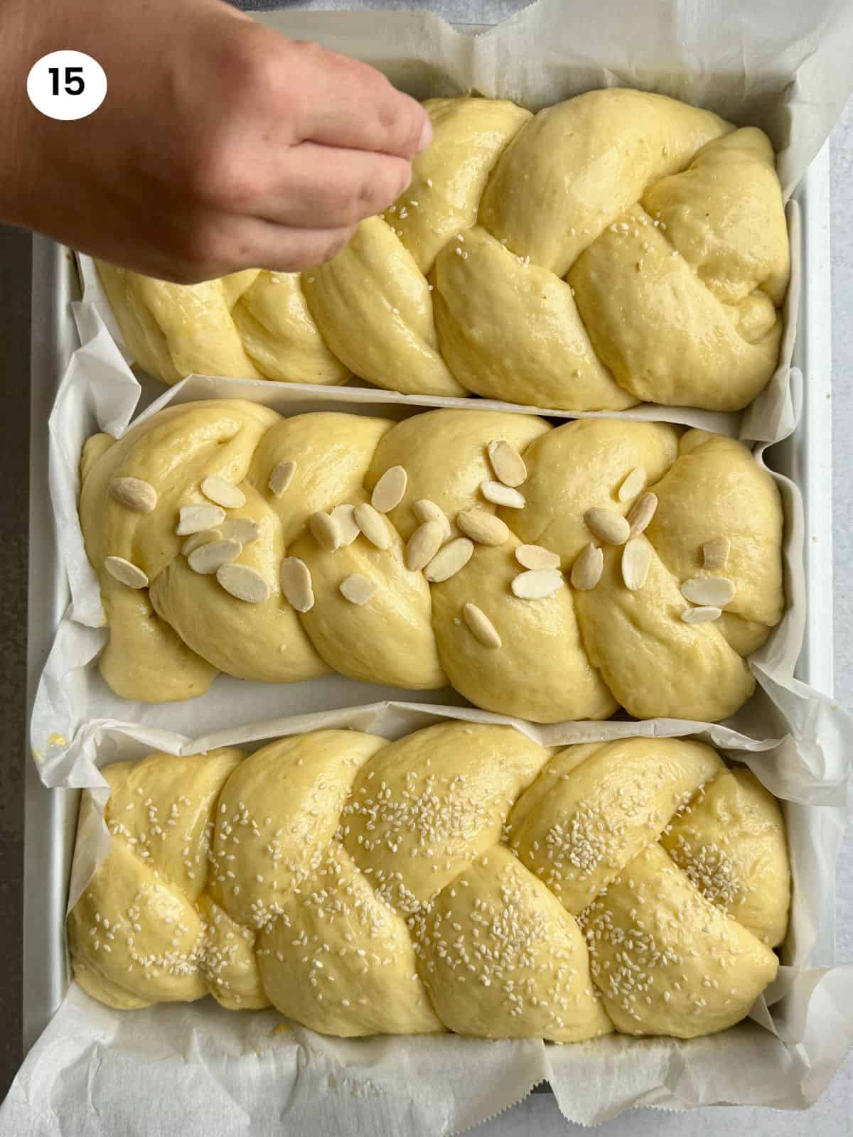 Decorating the sweet breads with sesame seeds and almond flakes.