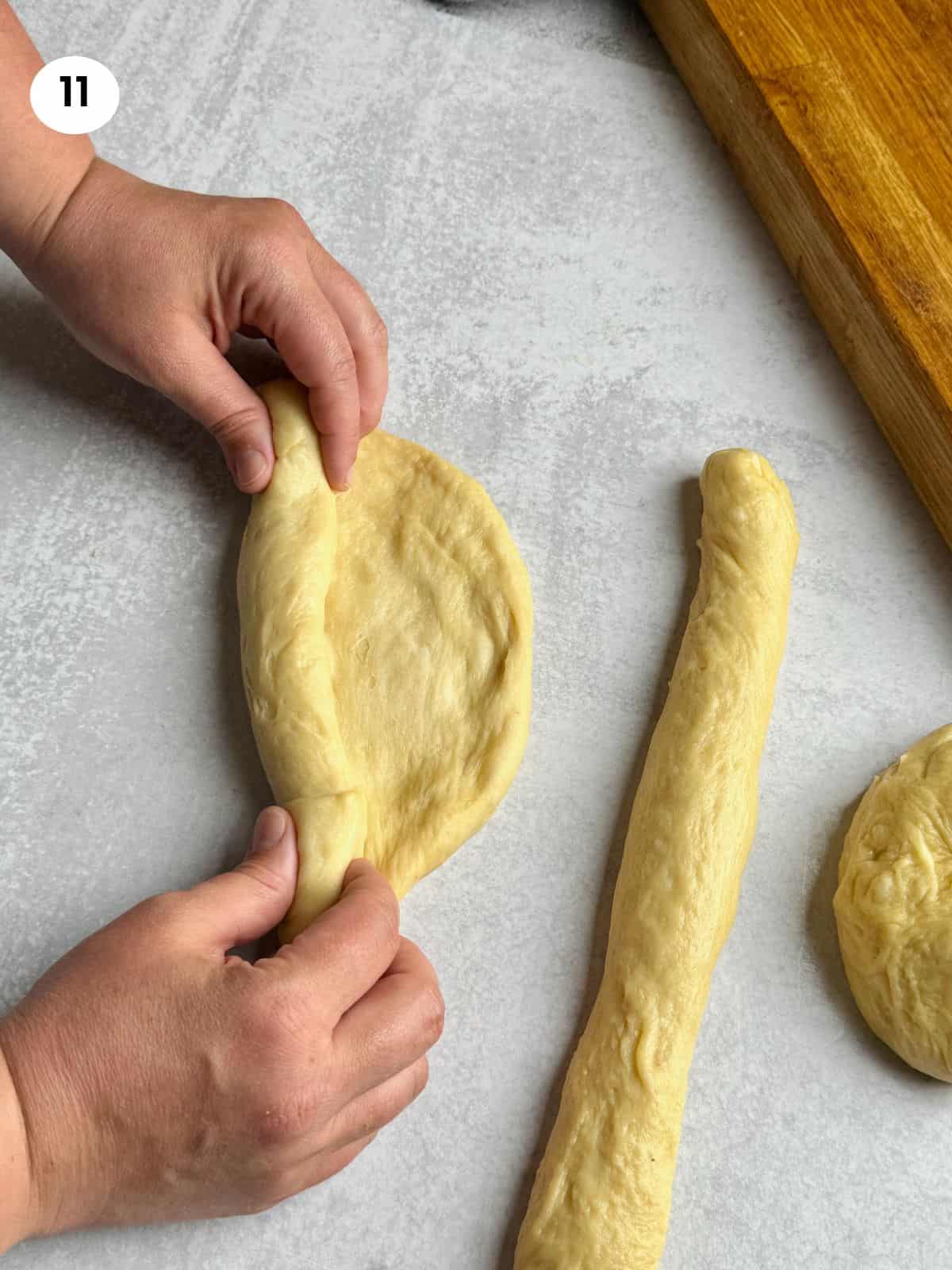 Folding each dough ball to create a stringy texture.