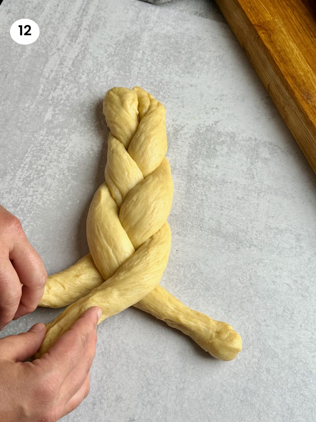 Braiding the three dough ropes.