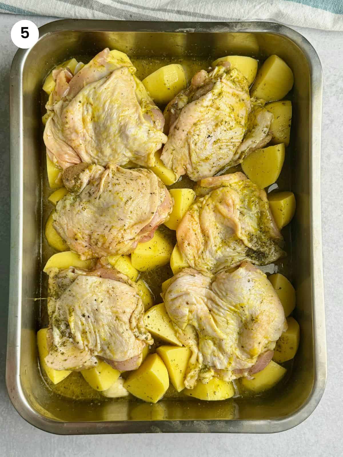 Chicken with potatoes ready to go in the oven.