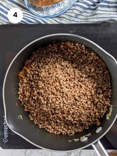 Adding the lentils and the rest of the ingredients to the pot.