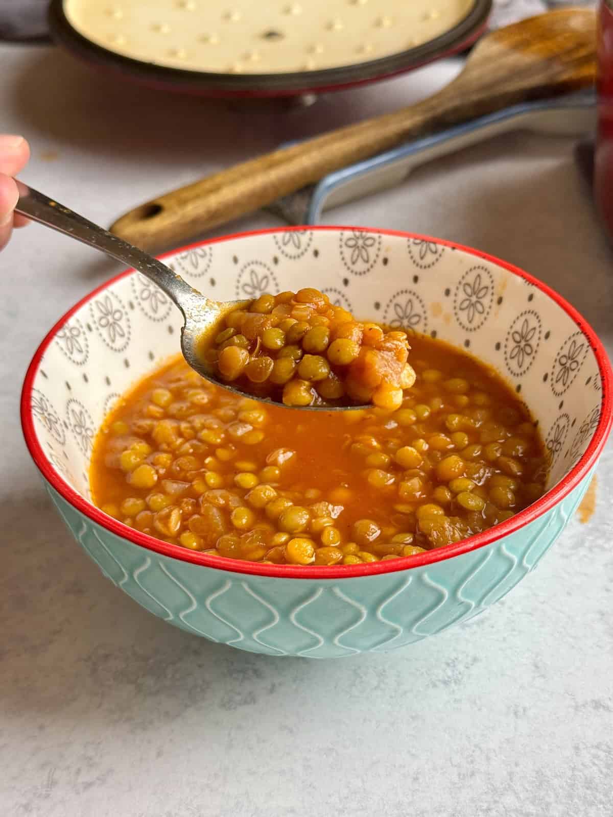 Lentil soup served in blue bowl.
