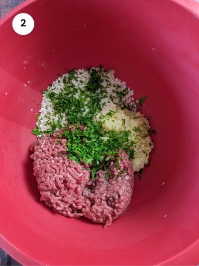 Adding all the ingredients for the meatballs to a bowl.