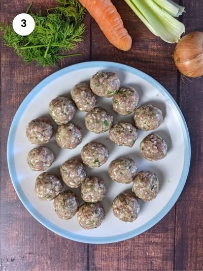 Shaped meatballs on a plate ready for the soup.