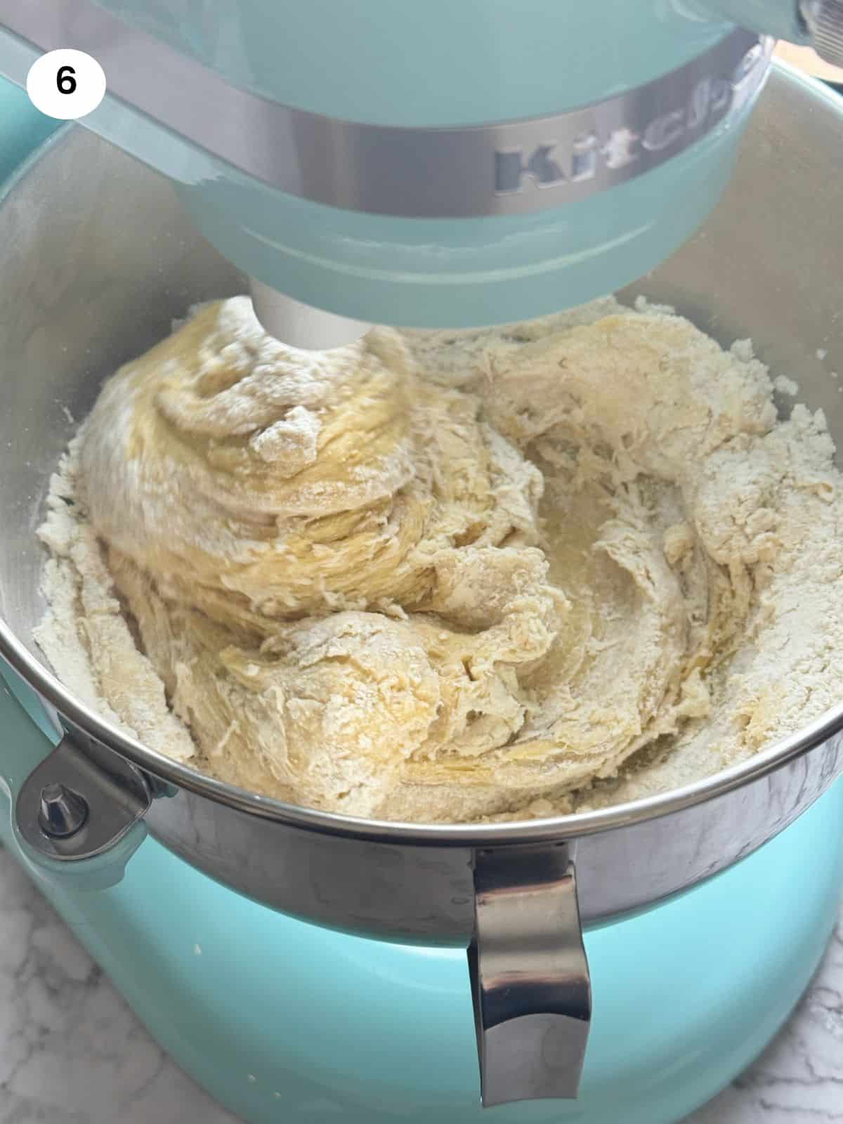 Mixing the ingredients with a hook in a stand mixer.