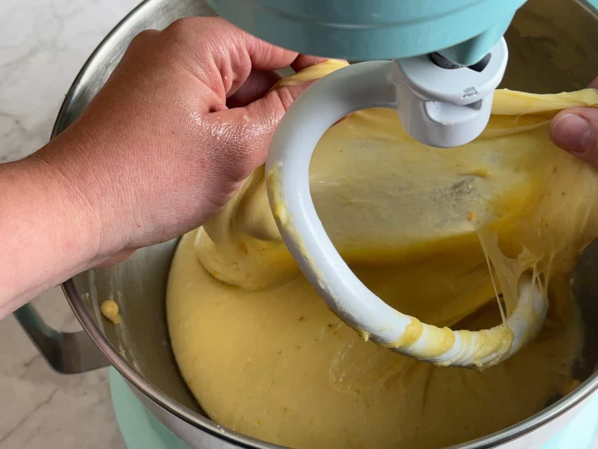 Stretching the dough with fingertips to pass the windowpane test.