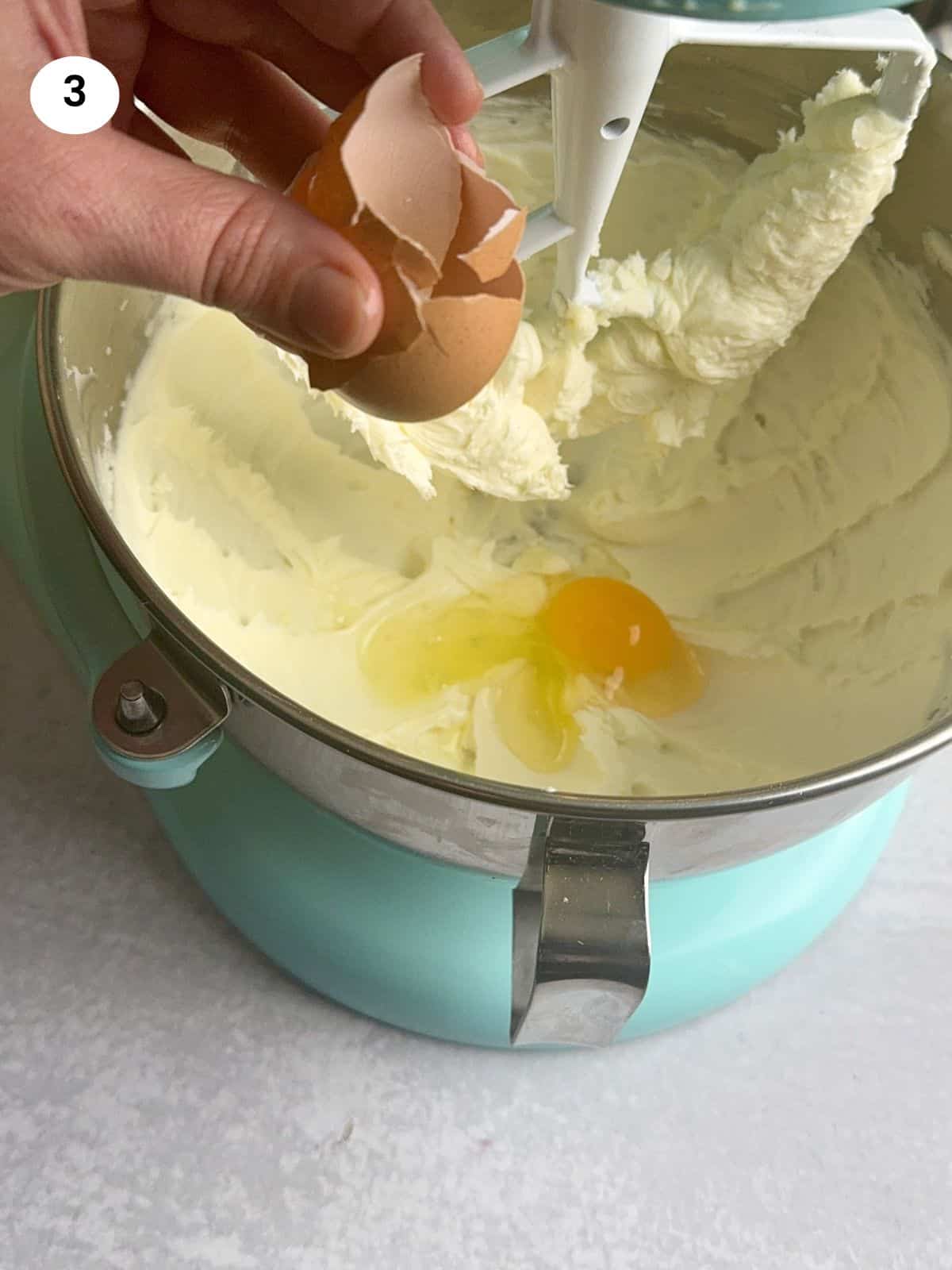 Adding the eggs to the batter.