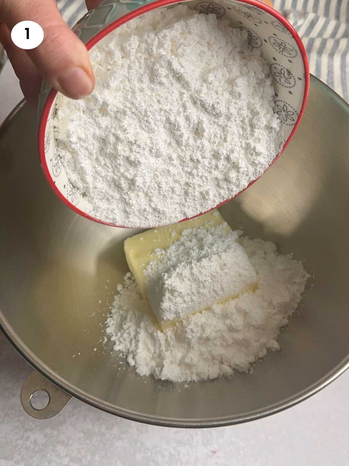 Mixing the powdered sugar and butter.