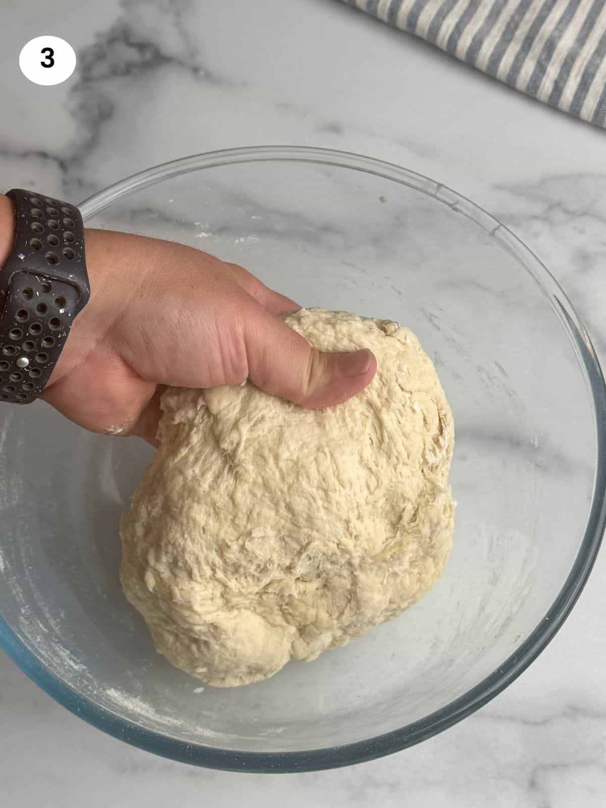Dough in a glass bowl.