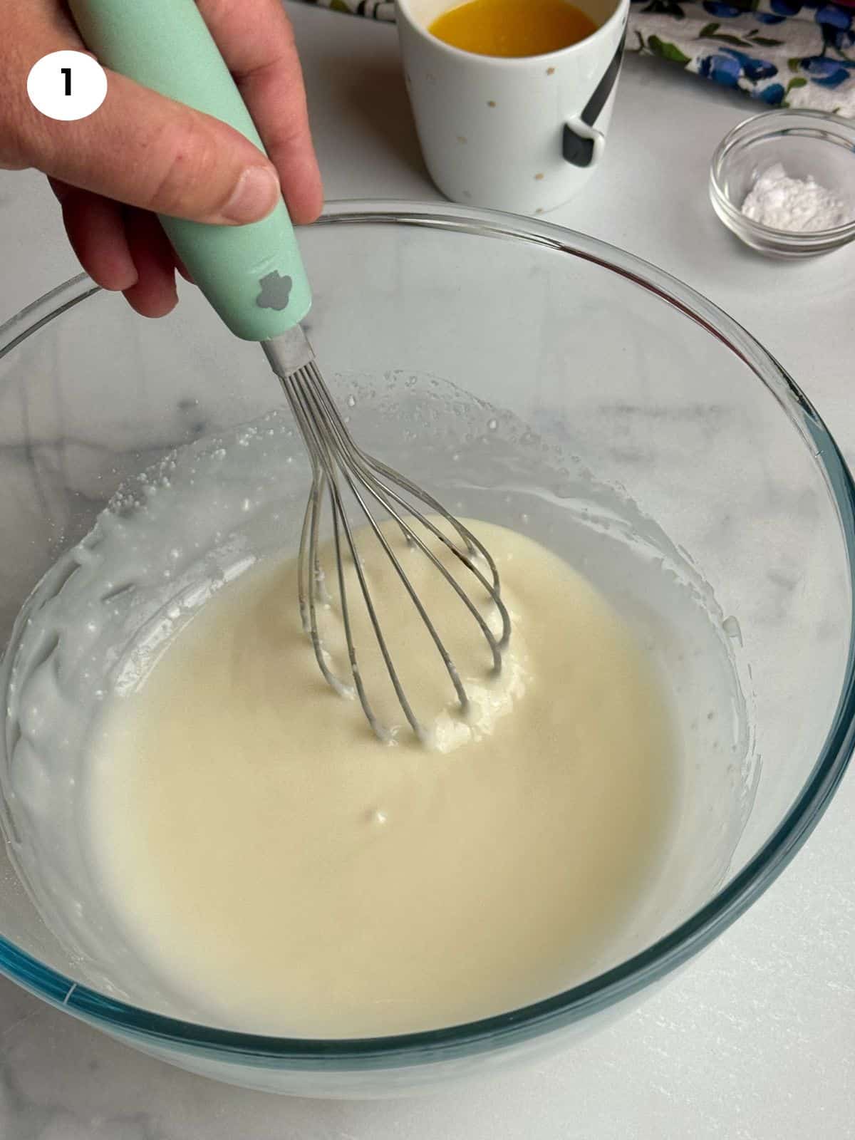 Mixed olive oil and powdered sugar in a bowl.