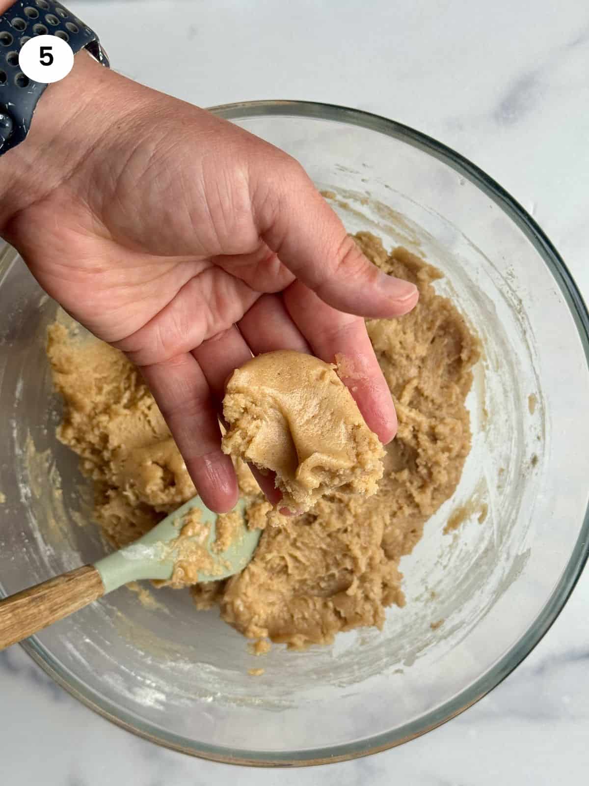 Showing a small piece of dough on a palm.