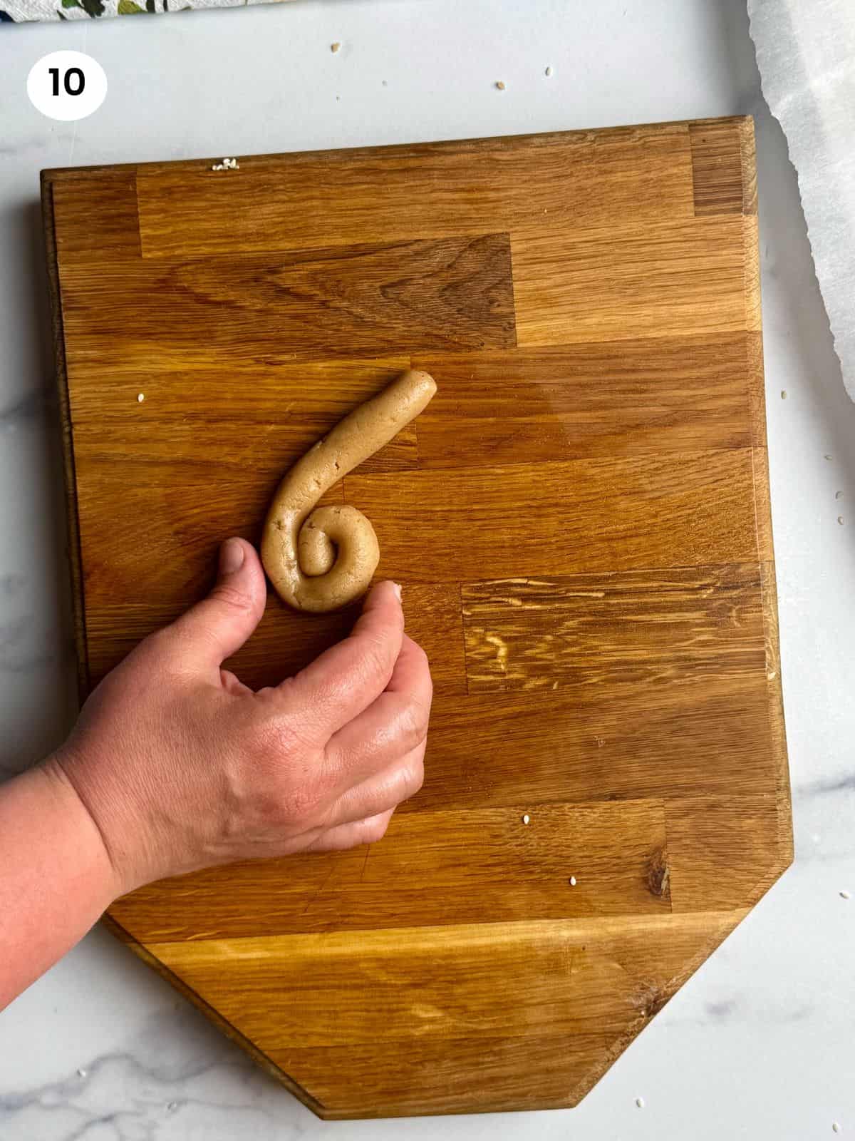 Shaping a koulouraki in a coil shape.