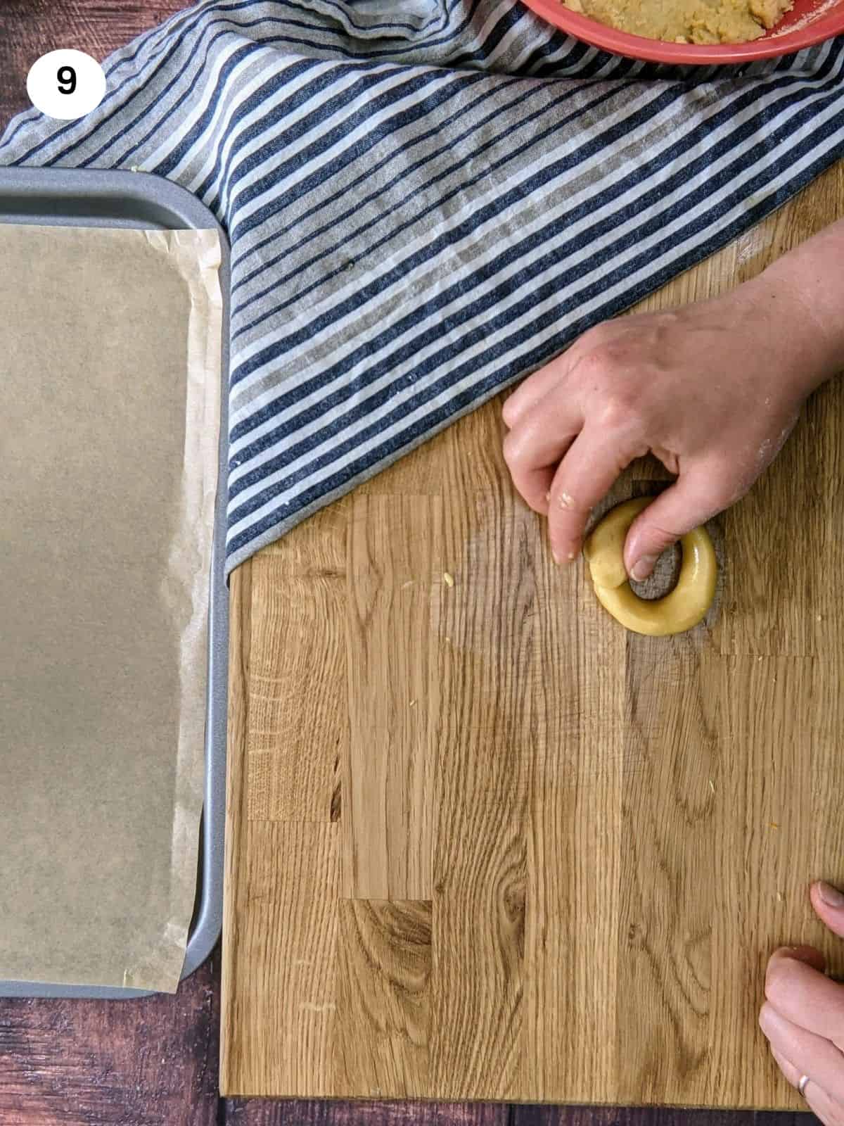 Shaping cookie dough into circle for greek orange cookies.