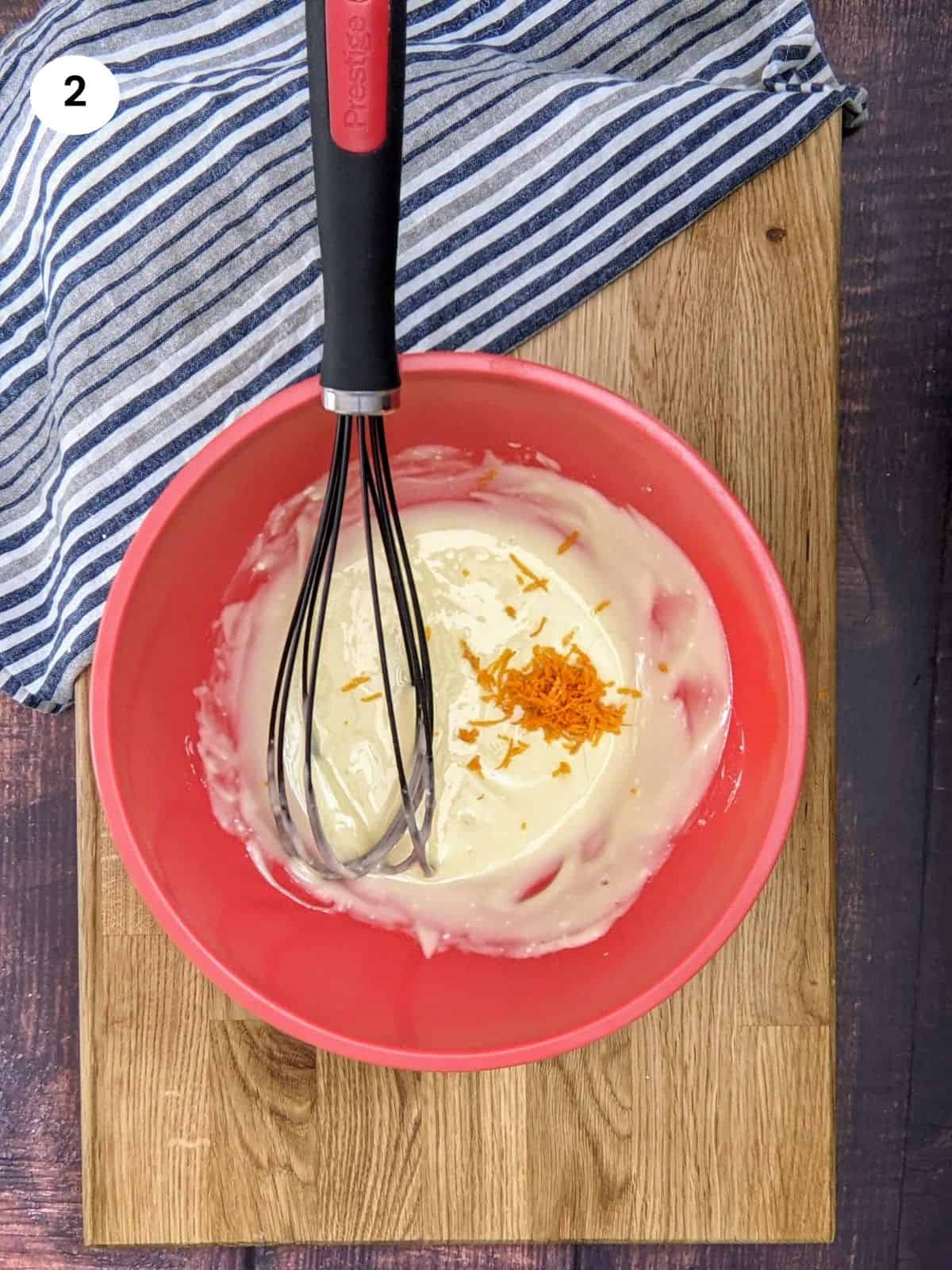 Adding orange zest to powdered sugar & oil mixture.