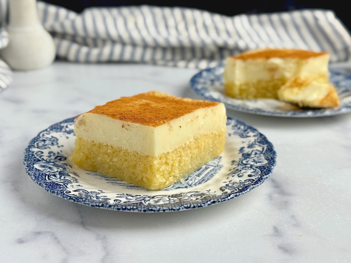 Served rectangular slice of the Greek cream and semolina dessert on a blue porcelain plate.